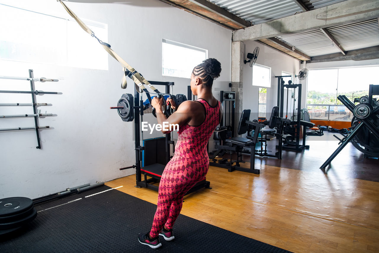 Muscular woman working out in a gym. fitness exercise in the studio.