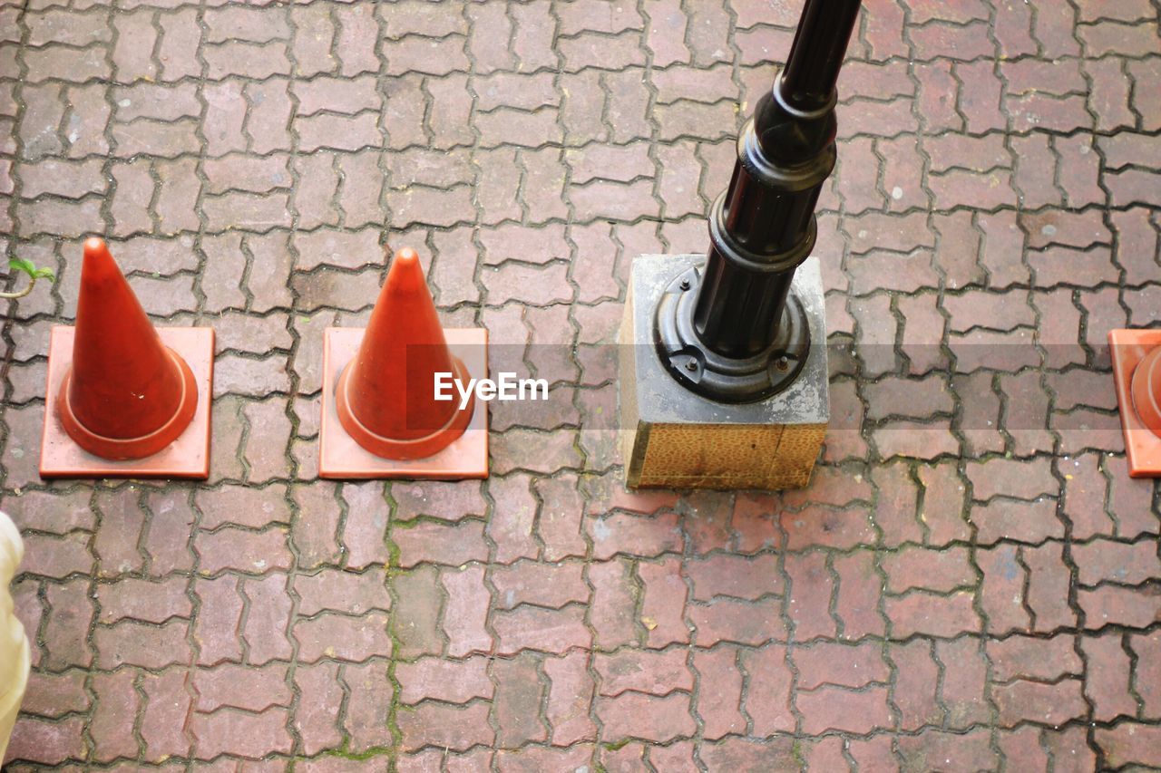 High angle view of traffic cones by pole on street