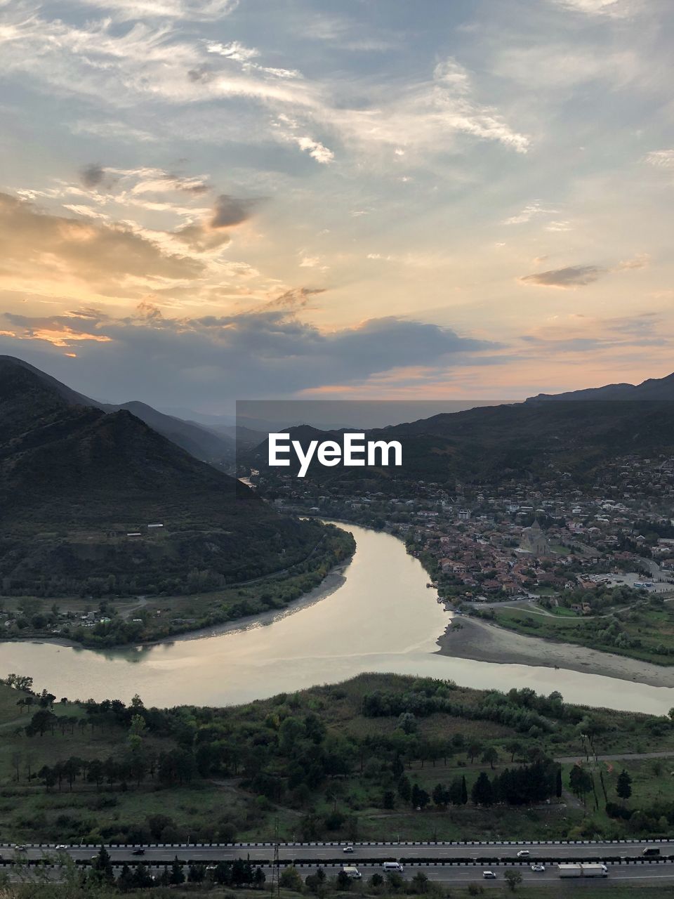 Scenic view of river against sky during sunset