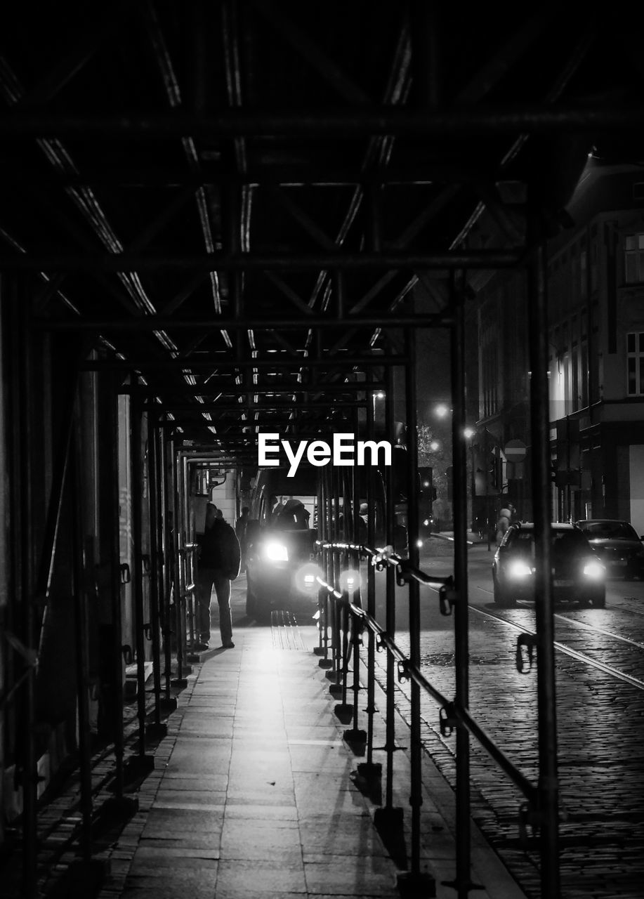 Covered walkway by street at night