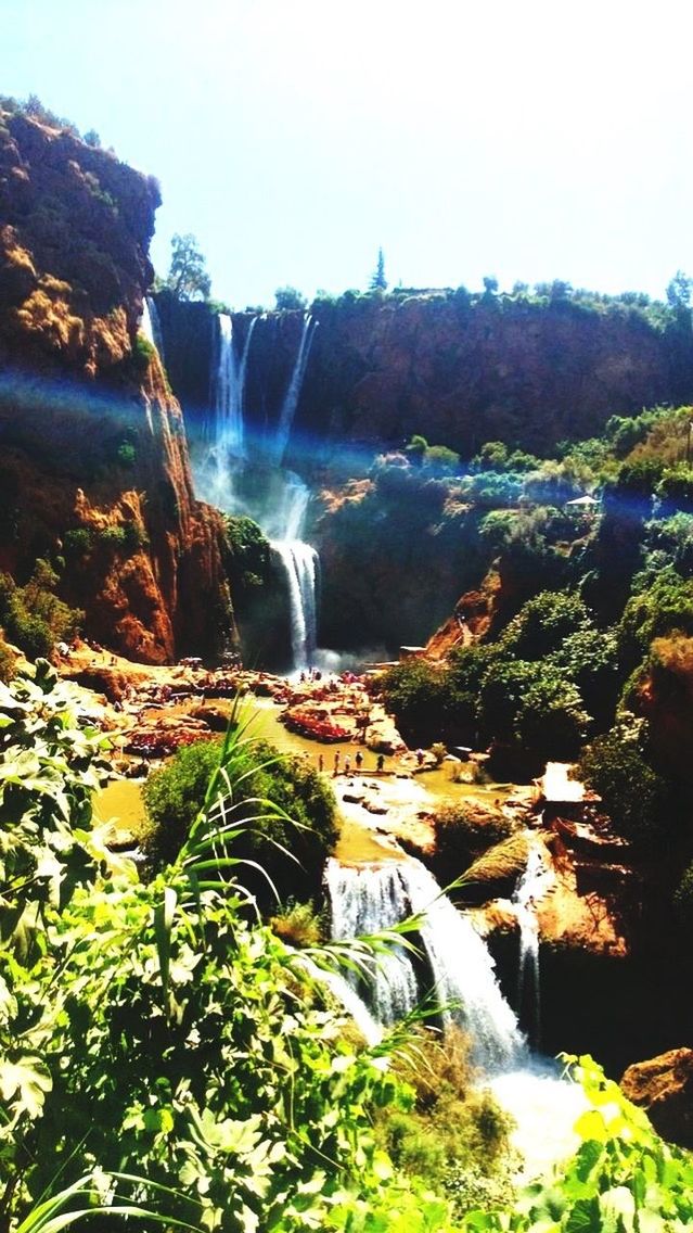 SCENIC VIEW OF WATERFALL AGAINST MOUNTAIN