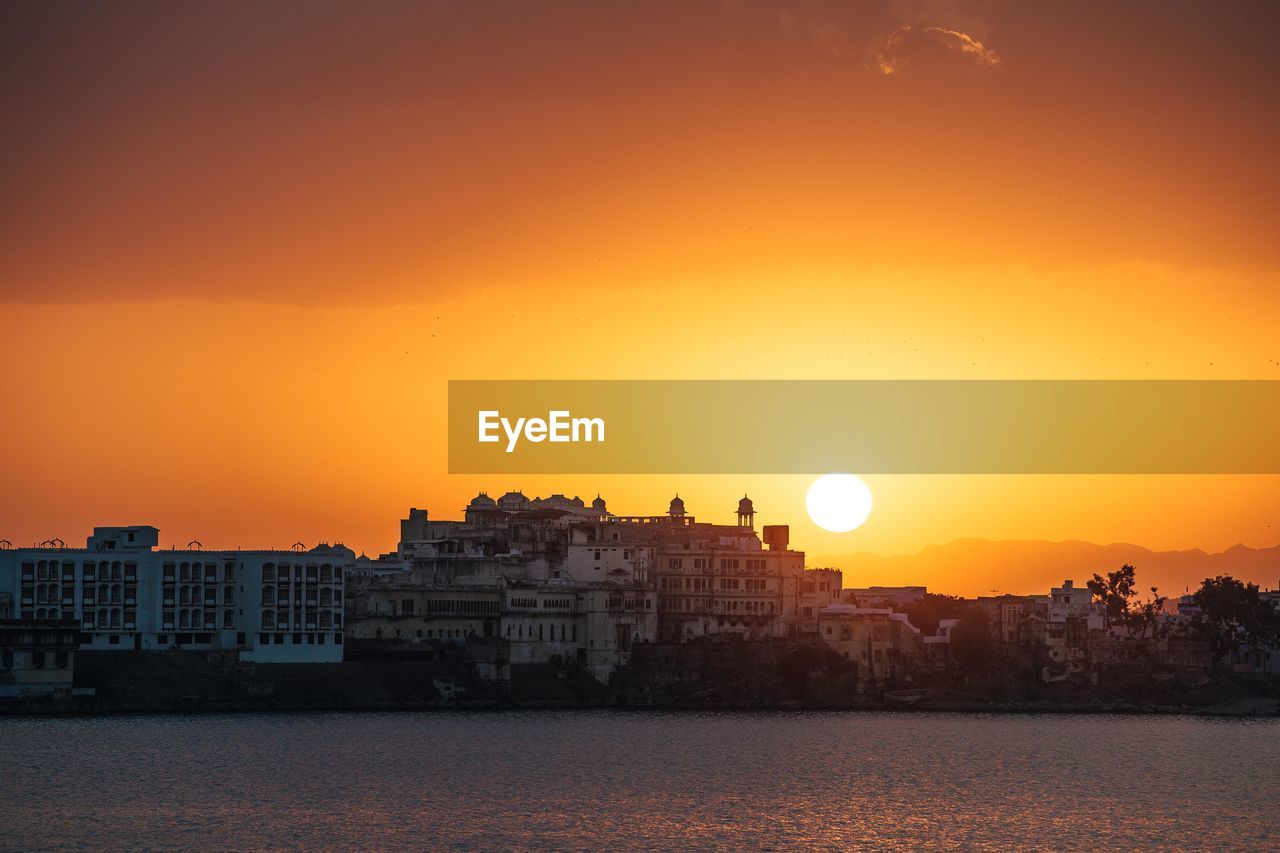 BUILDINGS AGAINST SKY AT SUNSET