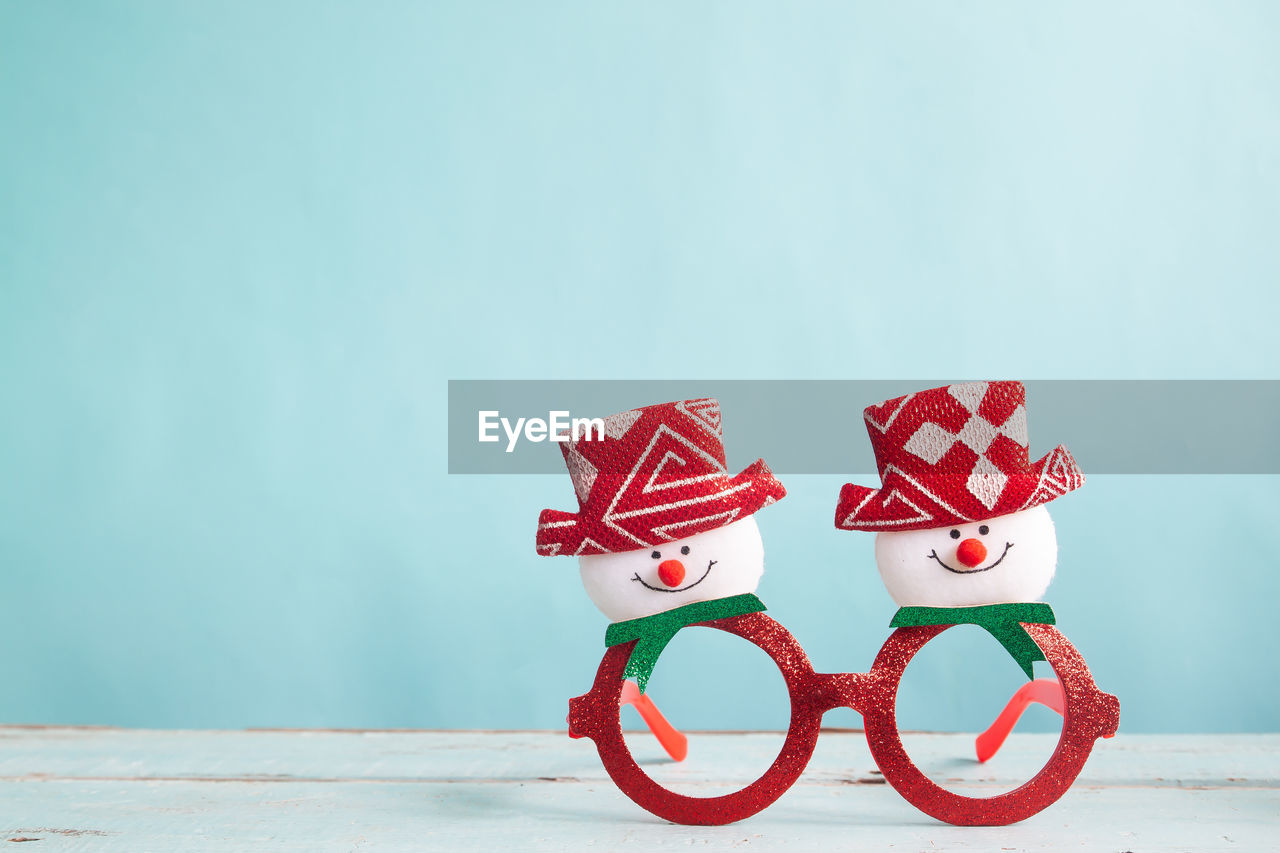 Close-up of christmas decoration on table against blue background