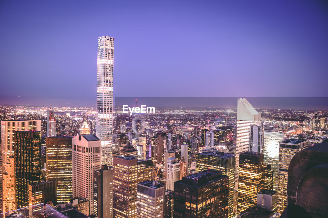 Aerial view of city lit up at night