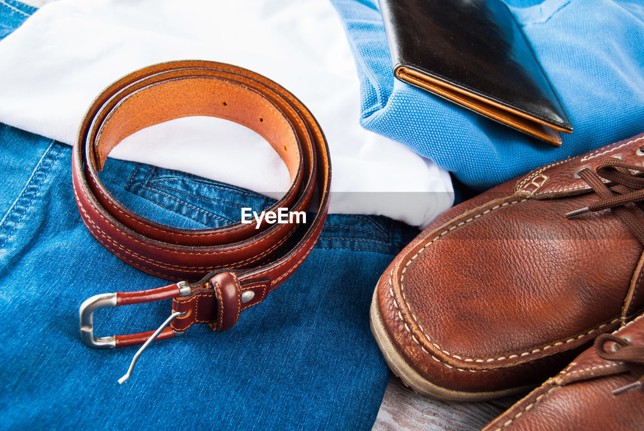 HIGH ANGLE VIEW OF LEATHER SHOES AND BLUE TABLE