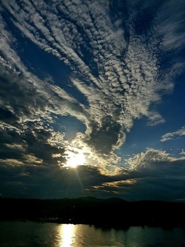 SUN SHINING THROUGH CLOUDS