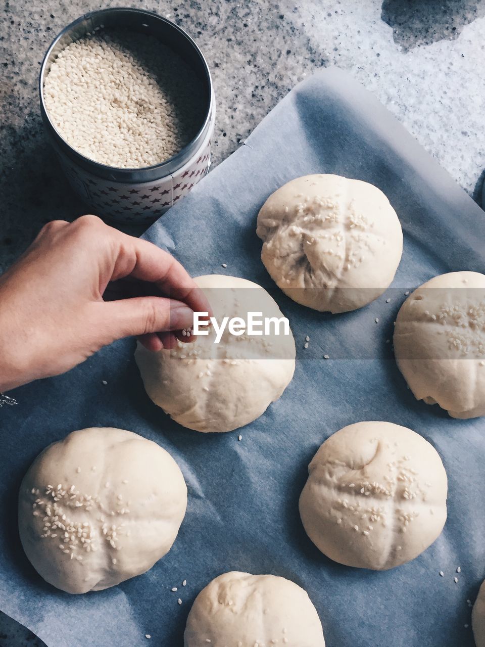 Cropped image of person preparing bread