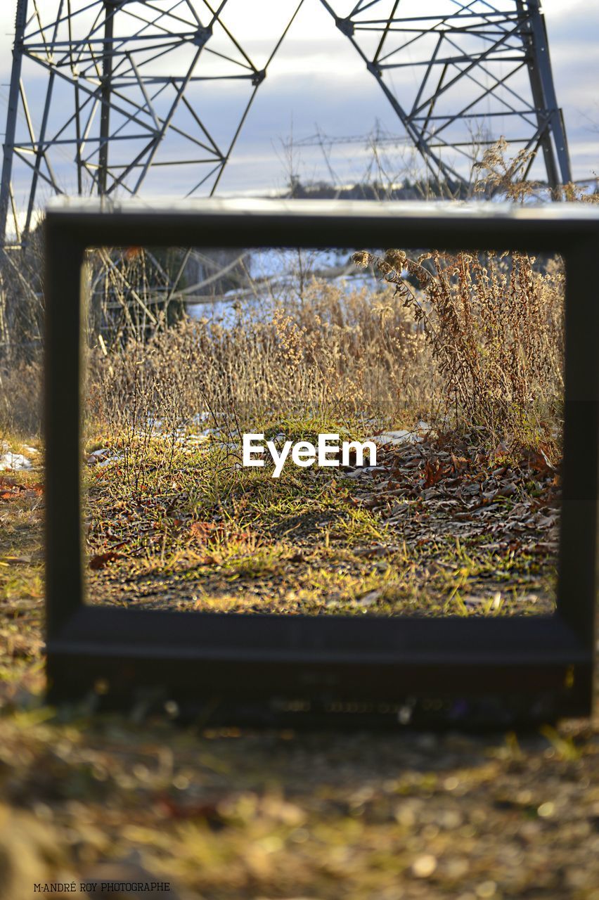 Optical illusion of field seen through damaged television set