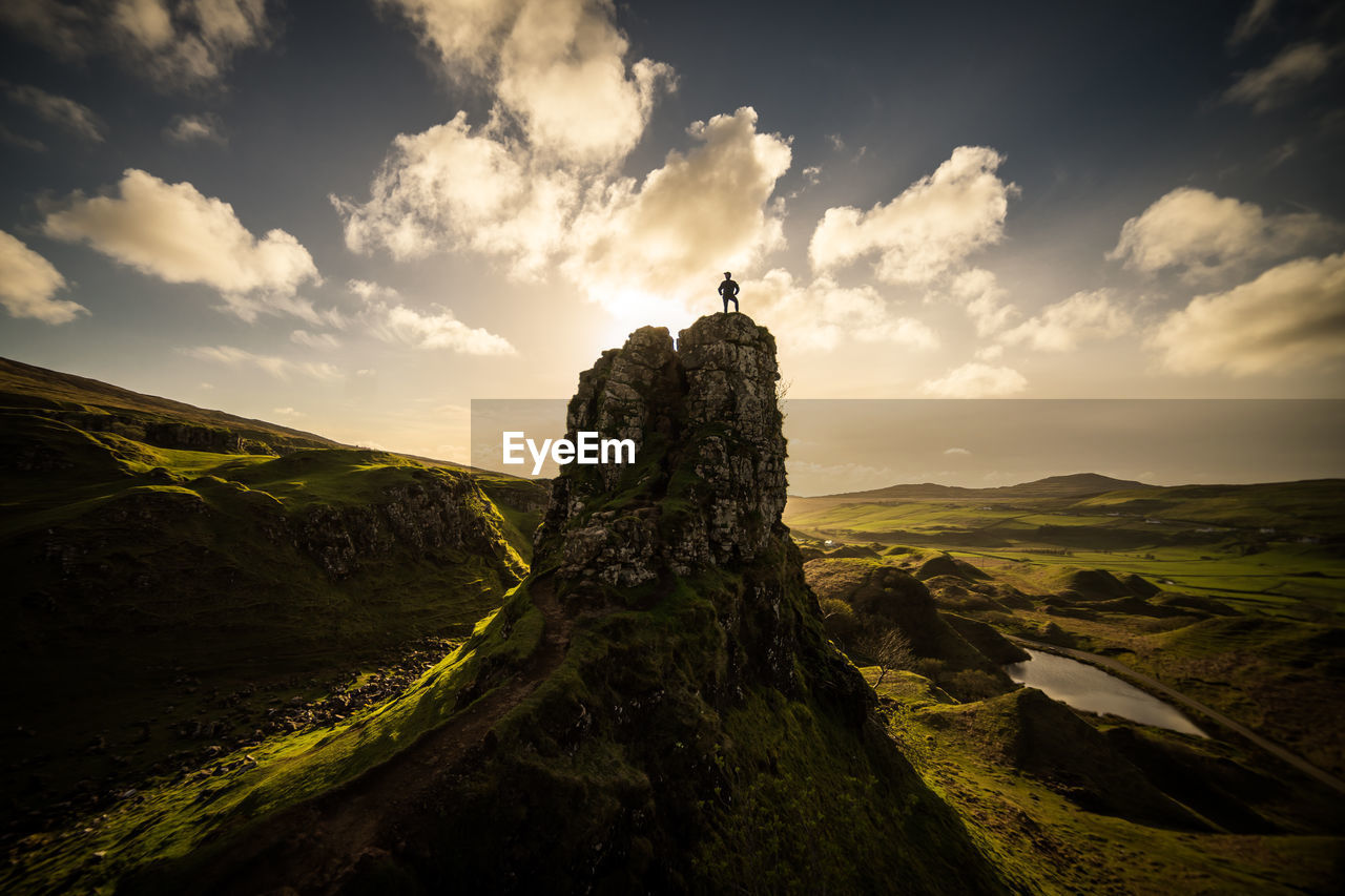 Scenic view of rock formation on field against sky