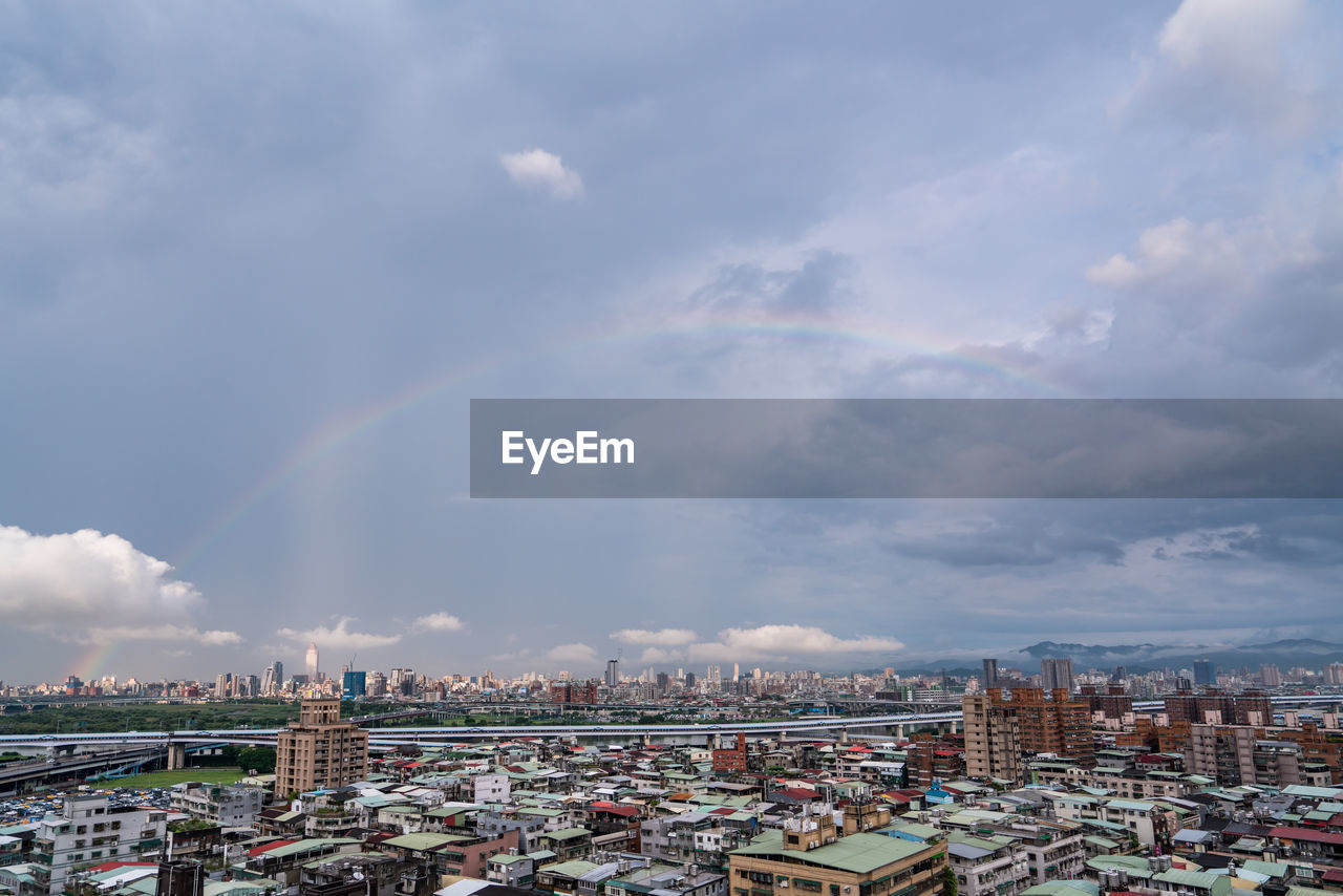 Panoramic view of rainbow over buildings in city