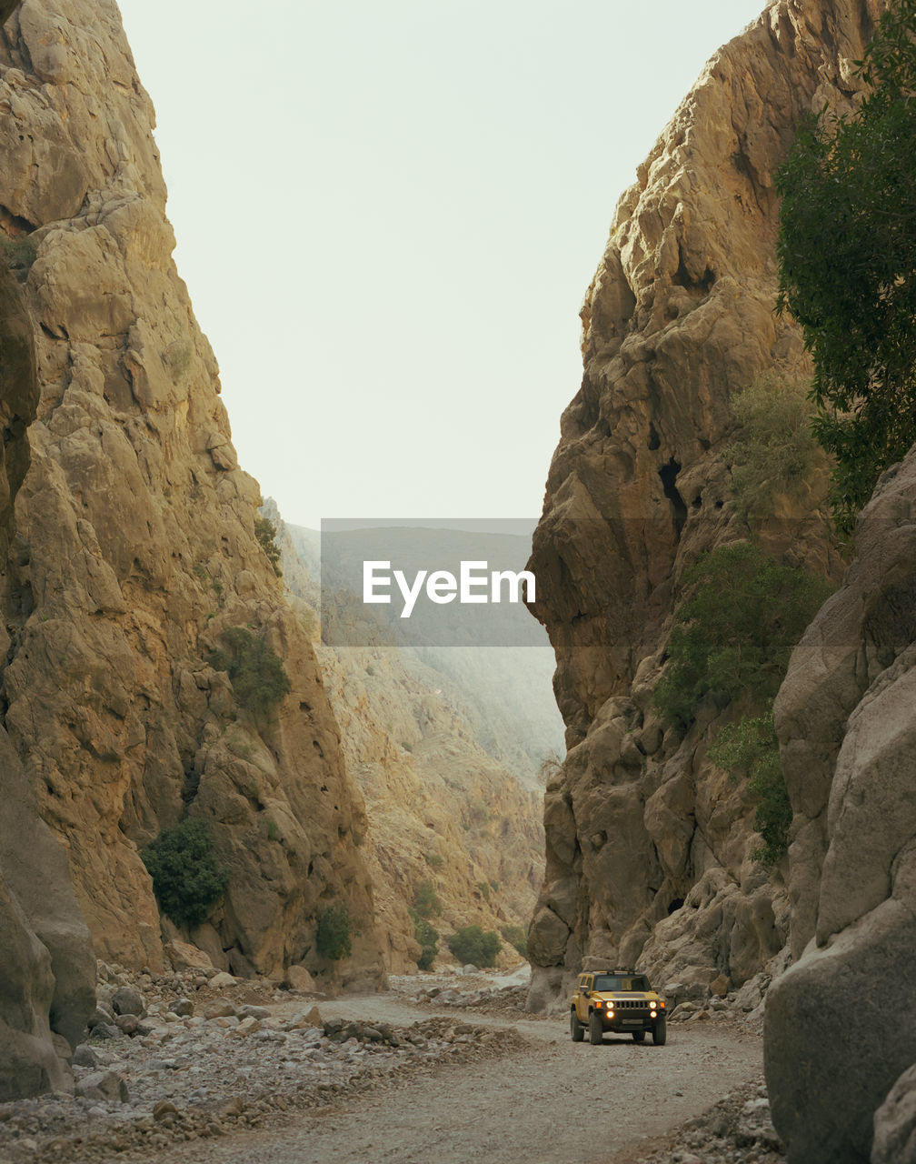 Vehicle on road amidst mountains