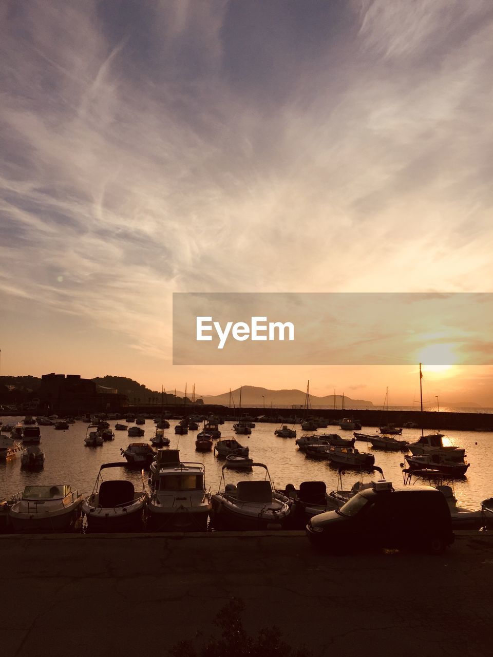 BOATS ON SEA AGAINST SKY AT SUNSET