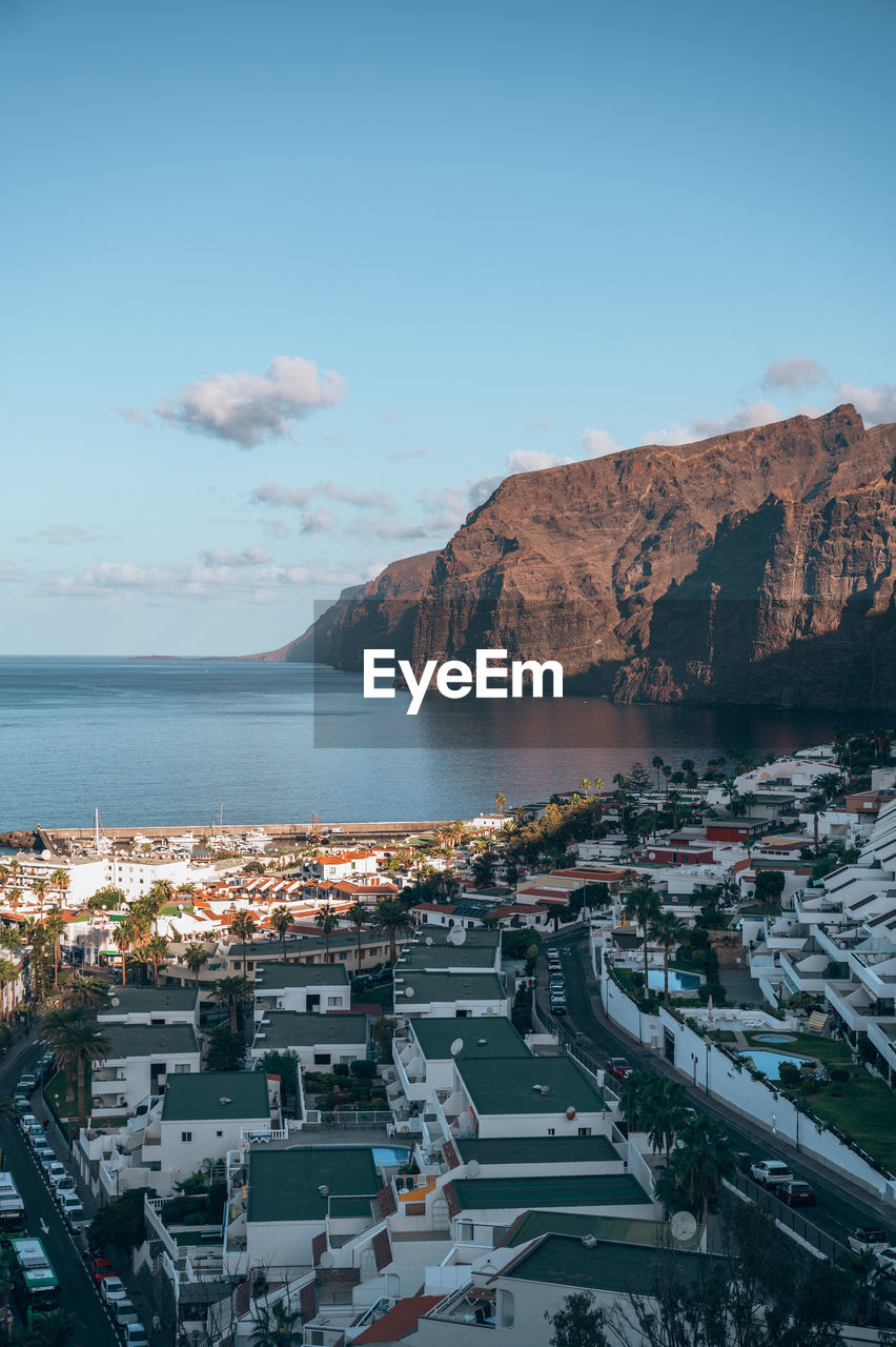 water, architecture, sea, coast, sky, city, nature, building exterior, transportation, travel destinations, built structure, mountain, aerial photography, high angle view, building, no people, travel, land, scenics - nature, bay, mode of transportation, cityscape, outdoors, horizon, beauty in nature, nautical vessel, environment, landscape, beach, harbor, dusk, day, blue, ocean, tourism, body of water, cloud, bay of water, aerial view, coastline