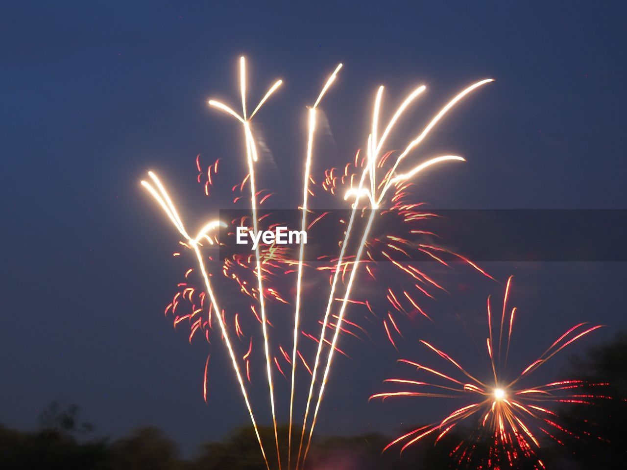 Sky illumed with fire crackers against clear blue sky