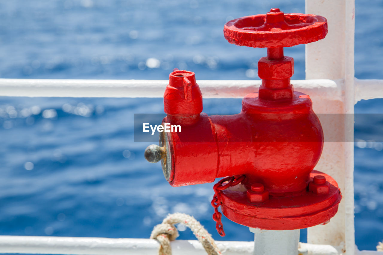 Close-up of red boat in sea against sky