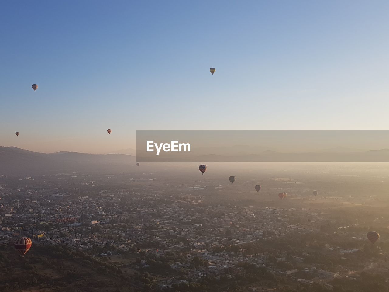 Hot air balloons flying in city