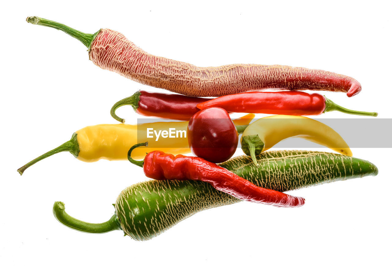 Close-up of chili peppers against white background