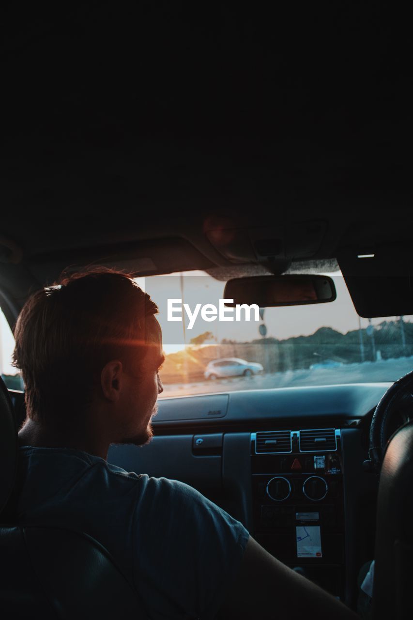 PORTRAIT OF BOY WEARING CAR IN BUS