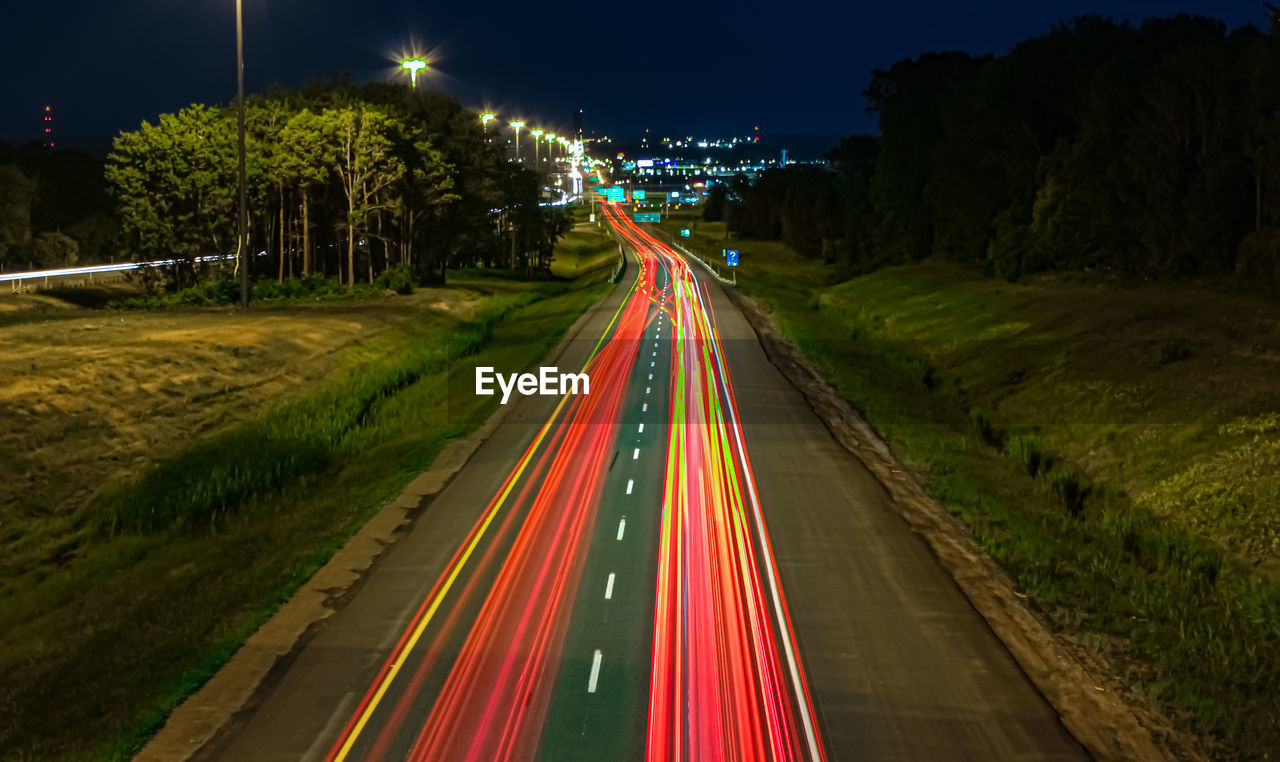 Light trails on road in city at night