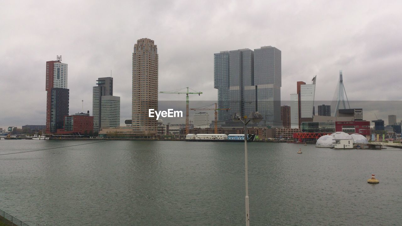 CITY SKYLINE AGAINST CLOUDY SKY