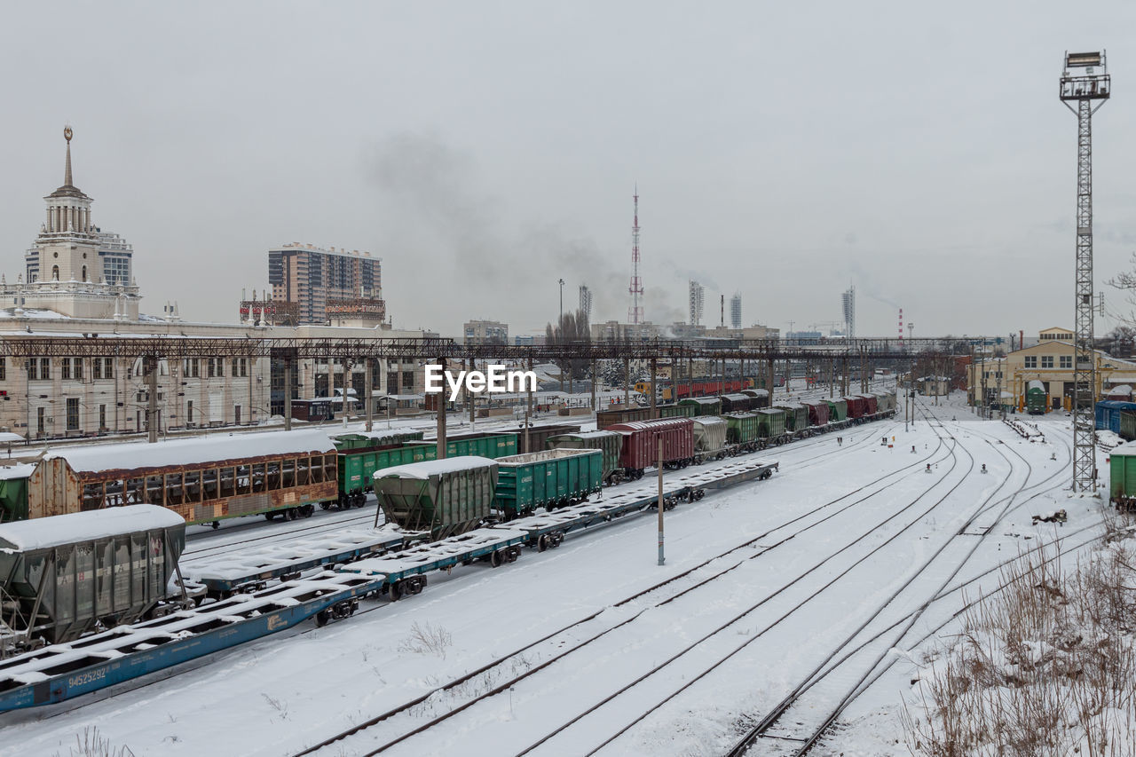 Snow-covered railway station krasnodar-1 with different types of cars on the track