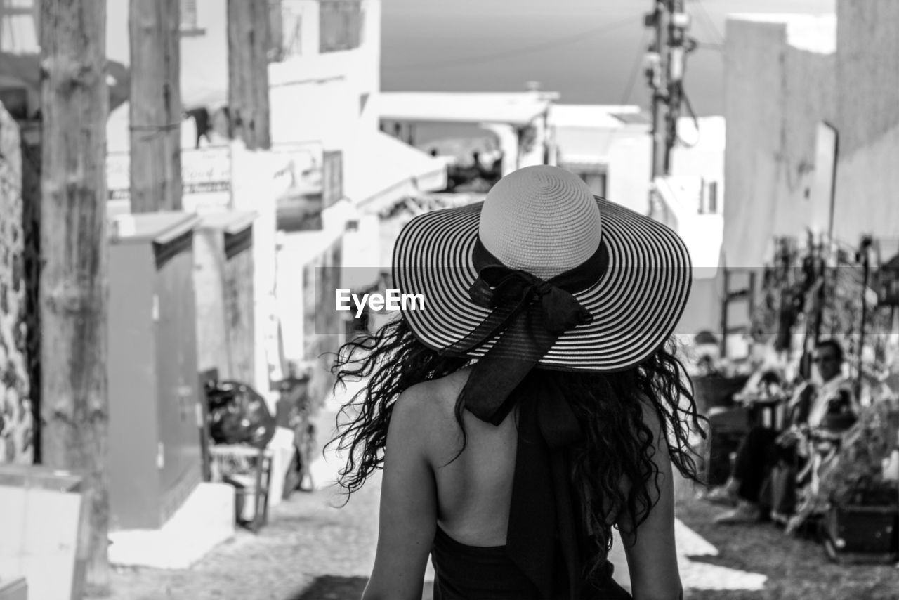 Rear view of woman wearing hat on street