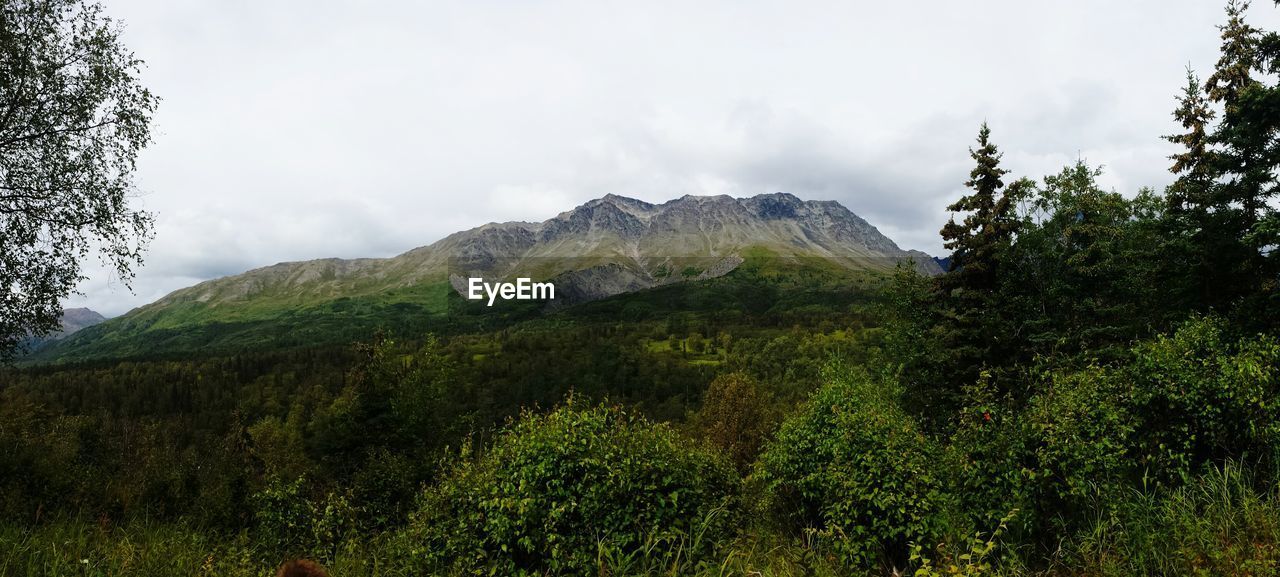 Scenic view of mountains against cloudy sky