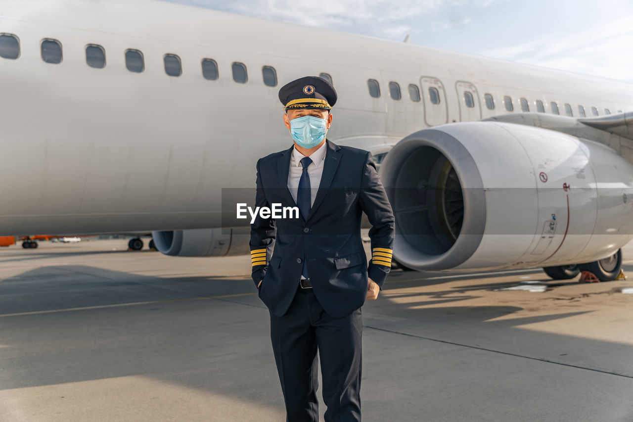 low angle view of airplane on airport runway against sky