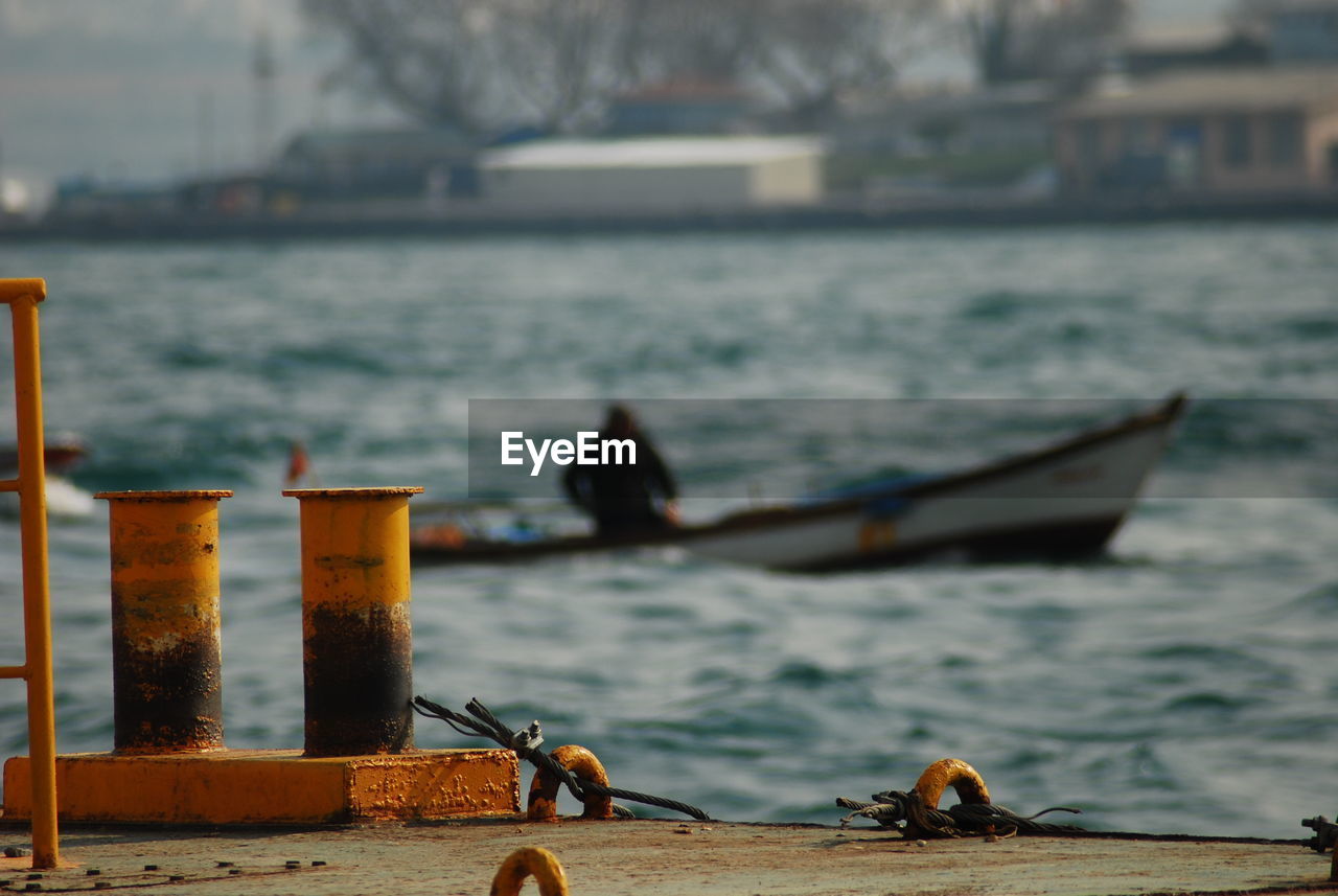 Close-up of boats in sea against the sky