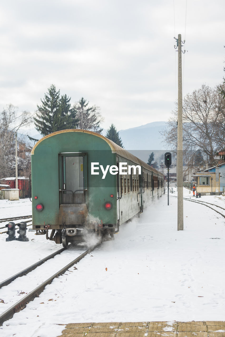 TRAIN ON RAILROAD TRACK IN WINTER