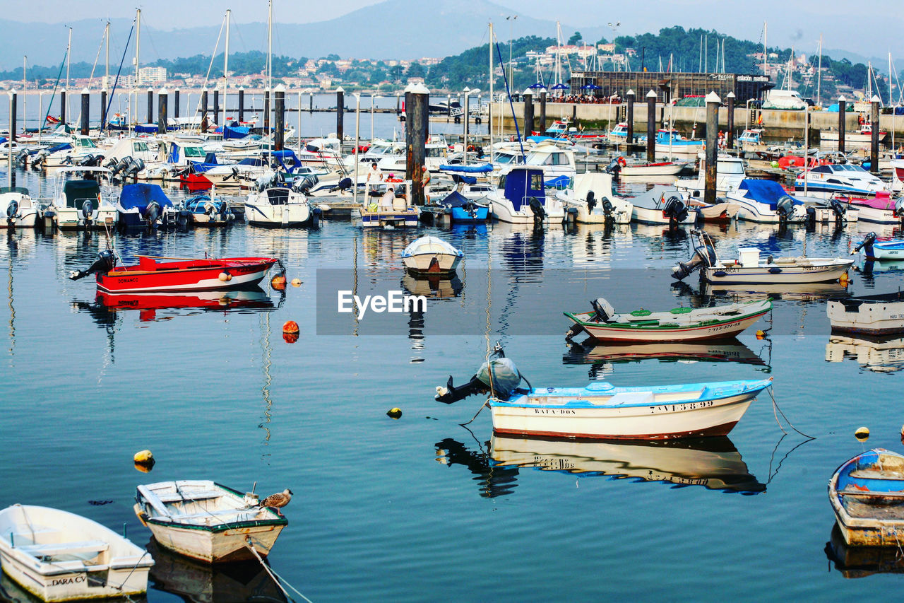 BOATS MOORED IN HARBOR