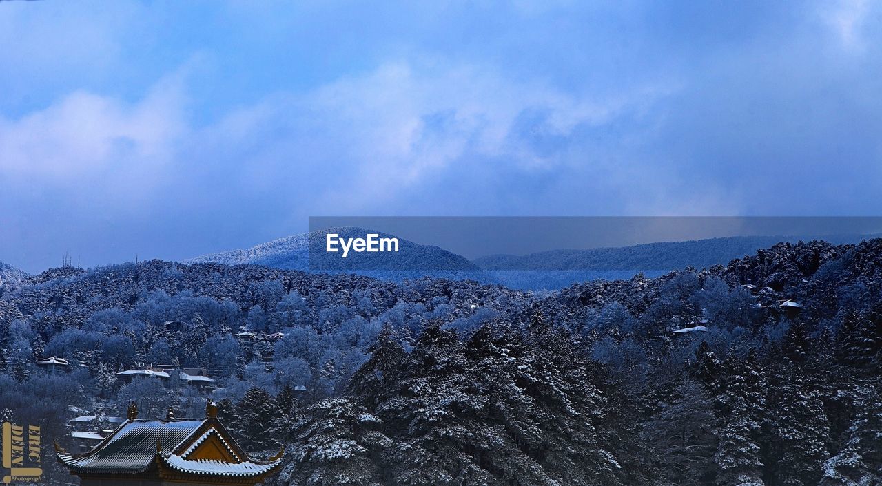 SNOW COVERED MOUNTAINS AGAINST BLUE SKY