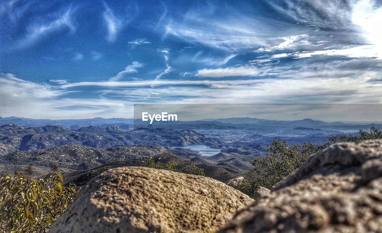 CLOSE-UP OF MOUNTAINS AGAINST SKY