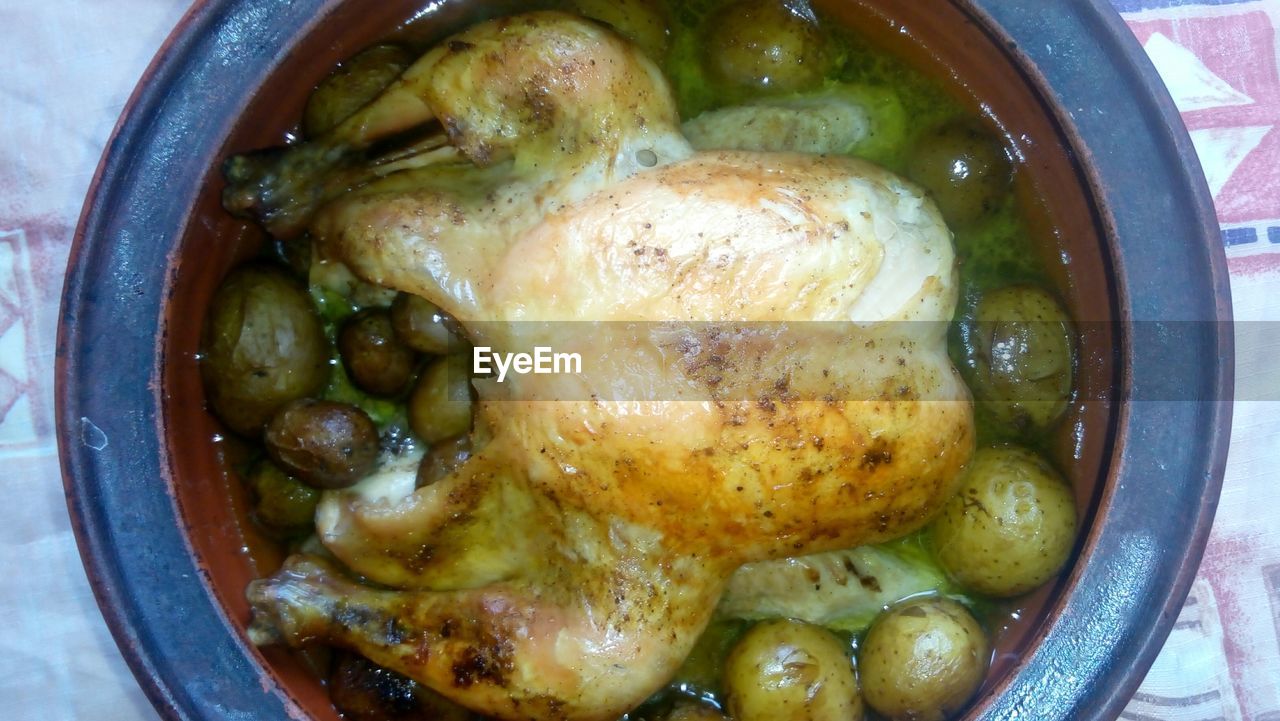 Close-up of chicken meat served with potatoes in bowl