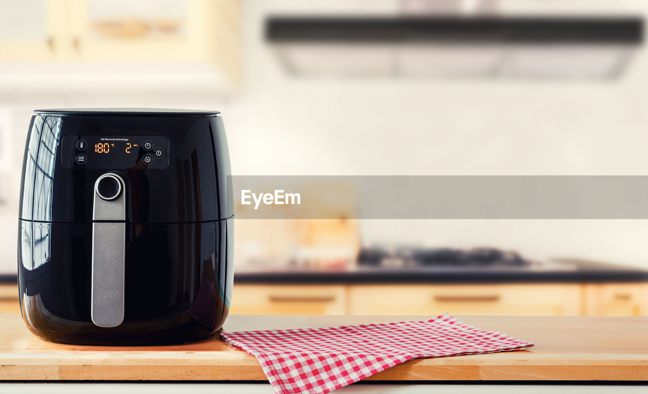 Air fryer machine cooking potato fried in kitchen. lifestyle of new normal cooking.