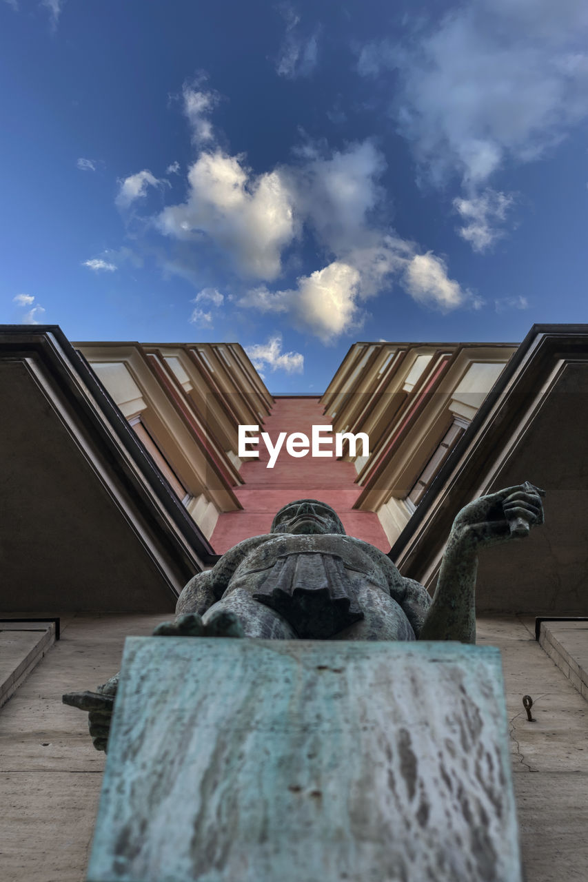 Low angle view of sculpture against building