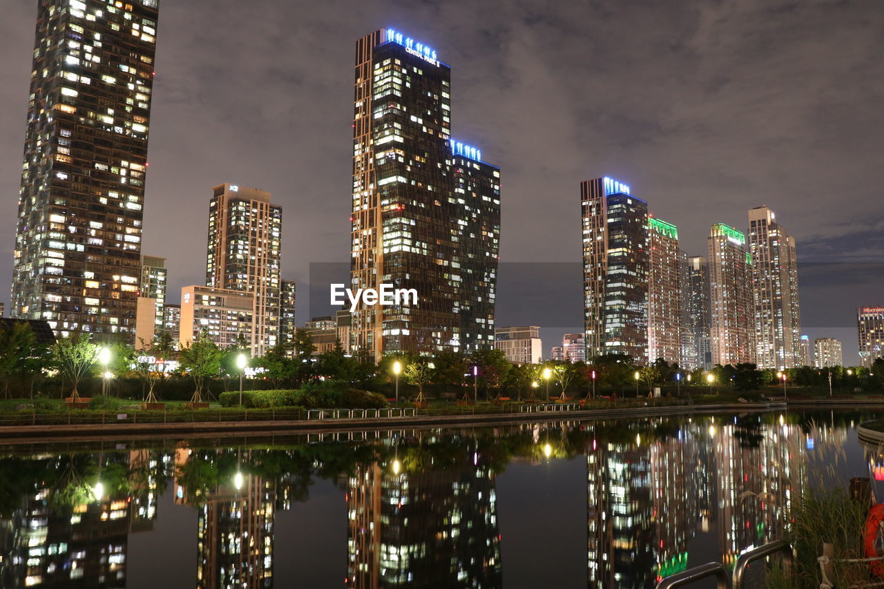 ILLUMINATED BUILDINGS IN CITY AT NIGHT