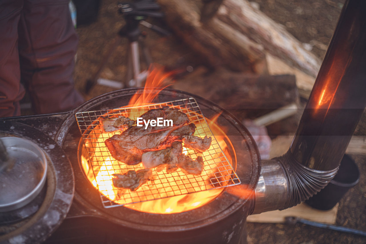 High angle view of fire on camp barbecue grill