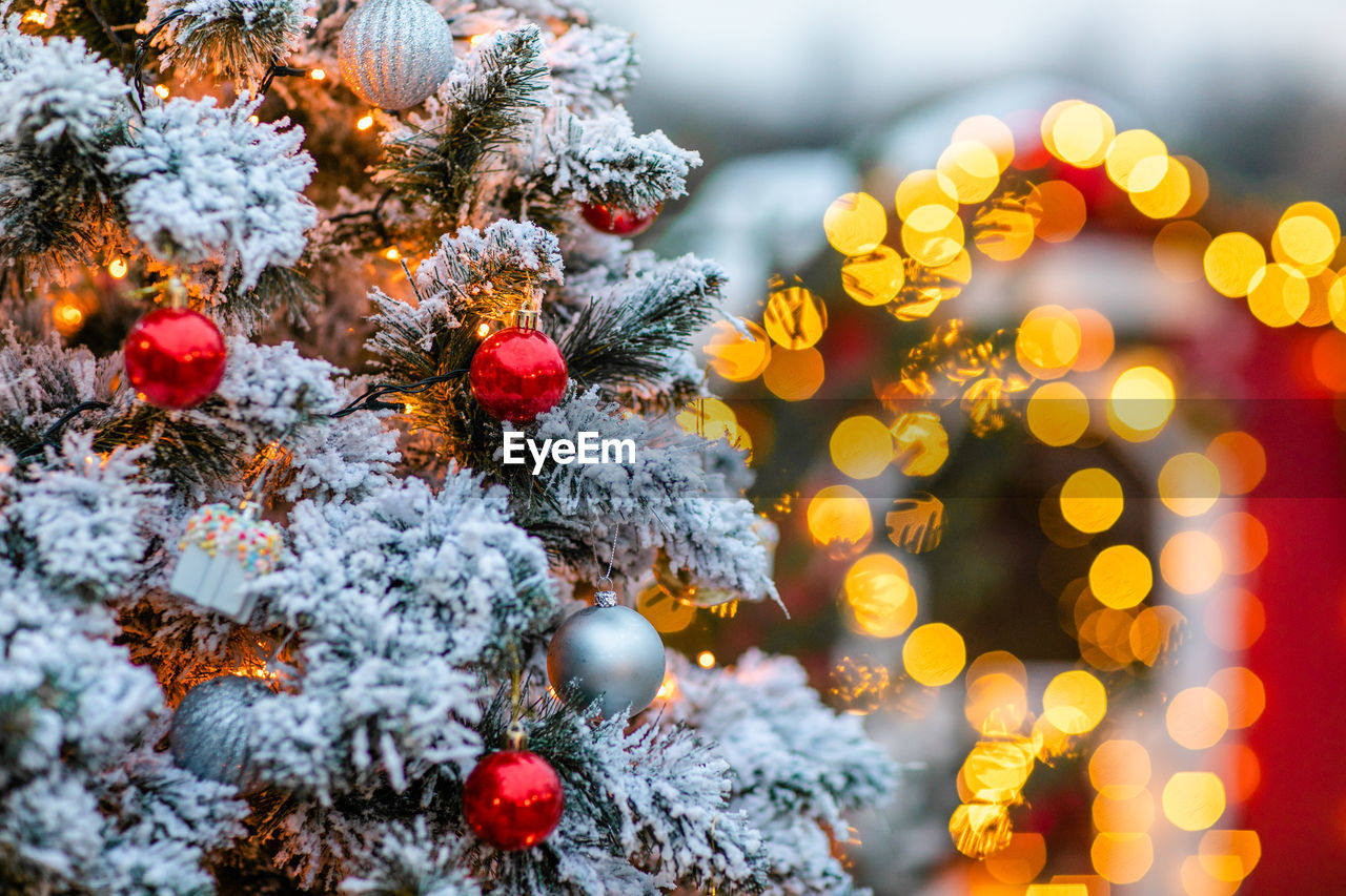 CLOSE-UP OF ILLUMINATED CHRISTMAS TREE IN WINTER