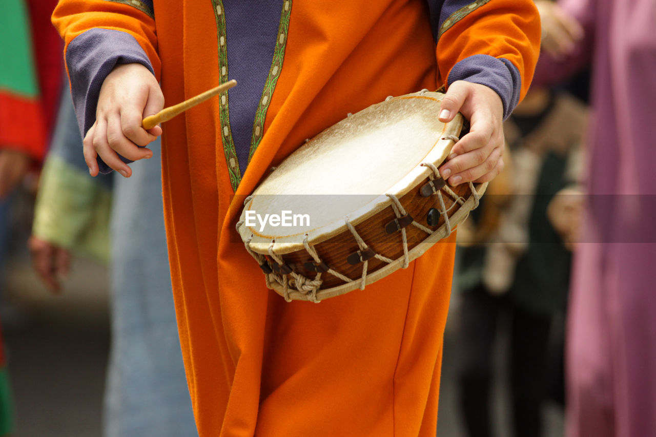 Midsection of person playing musical instrument