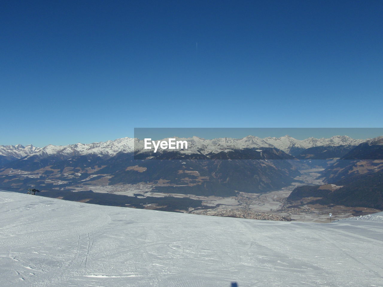 Scenic view of mountains against clear blue sky