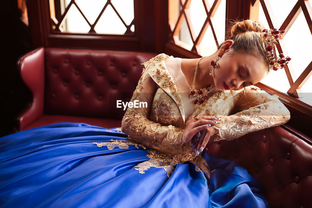 High angle view of bride relaxing on sofa at home