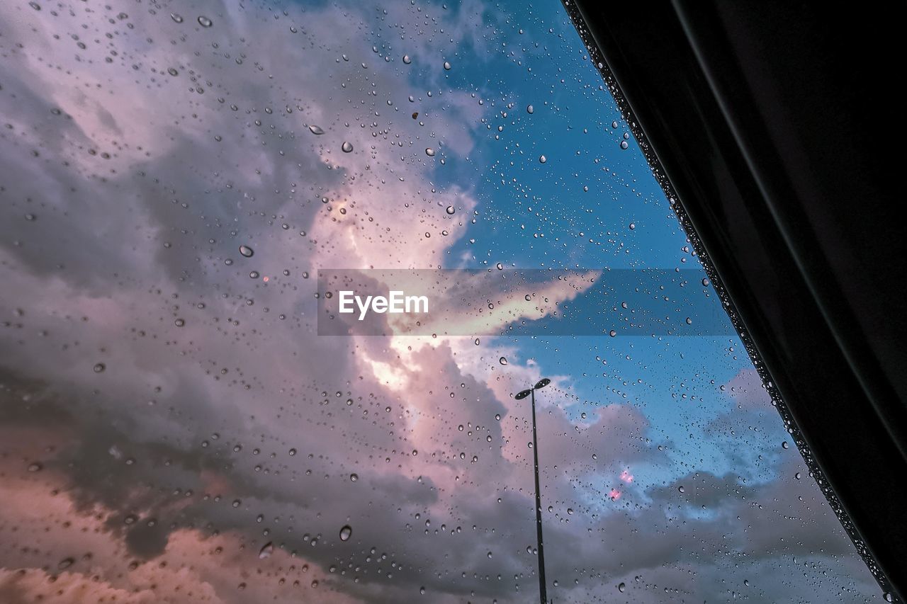 Sky seen through wet glass window