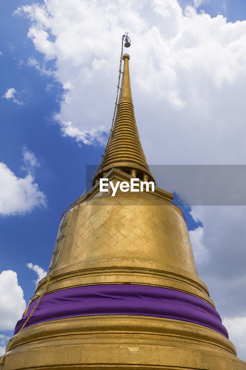 Low angle view of statue of temple against cloudy sky