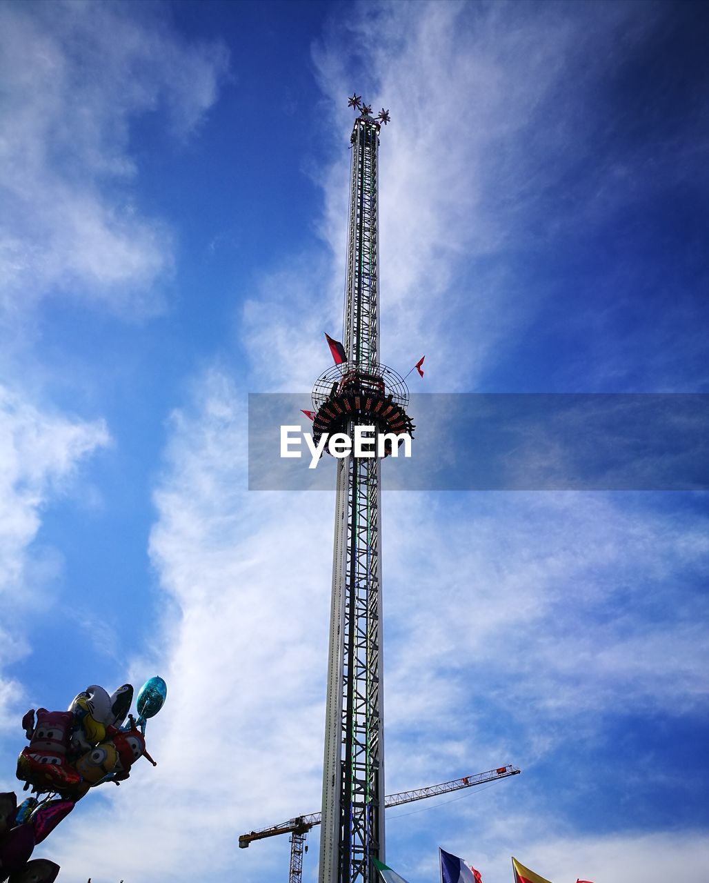 LOW ANGLE VIEW OF ROLLERCOASTER RIDE AGAINST BLUE SKY