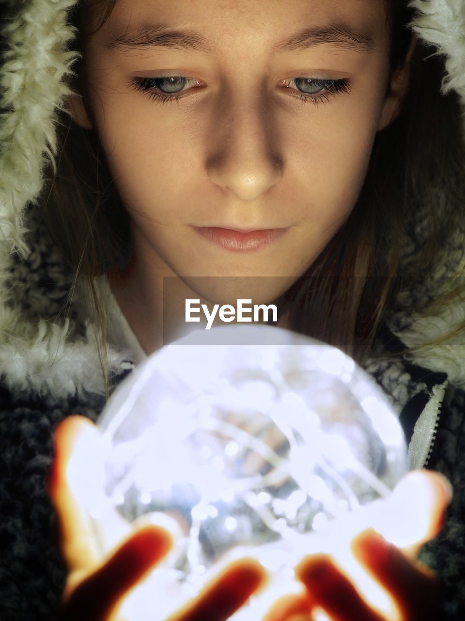 Close-up of girl holding illuminated lighting equipment