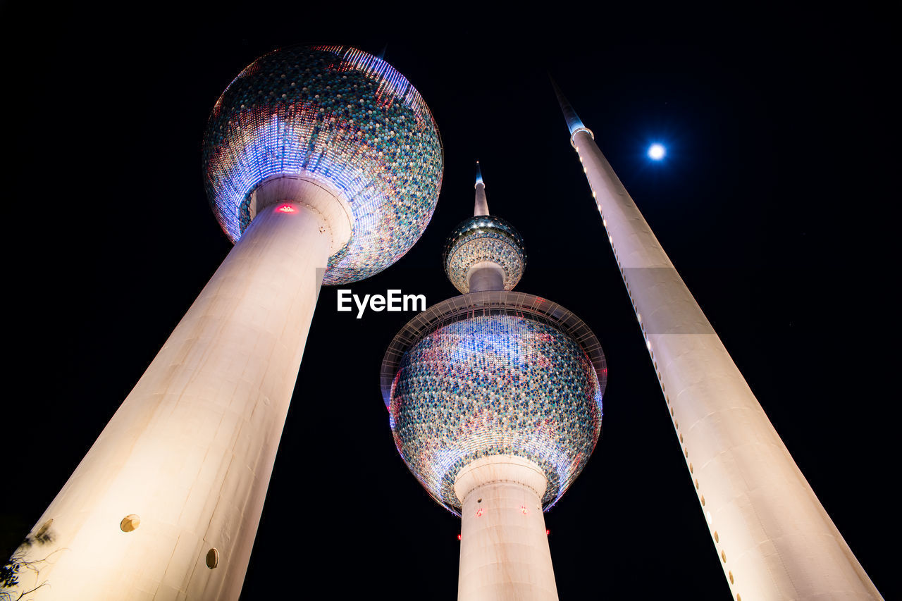 LOW ANGLE VIEW OF ILLUMINATED TOWER