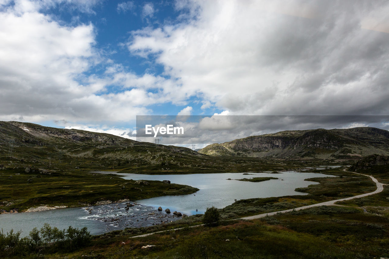 Scenic view of lake and mountains against sky