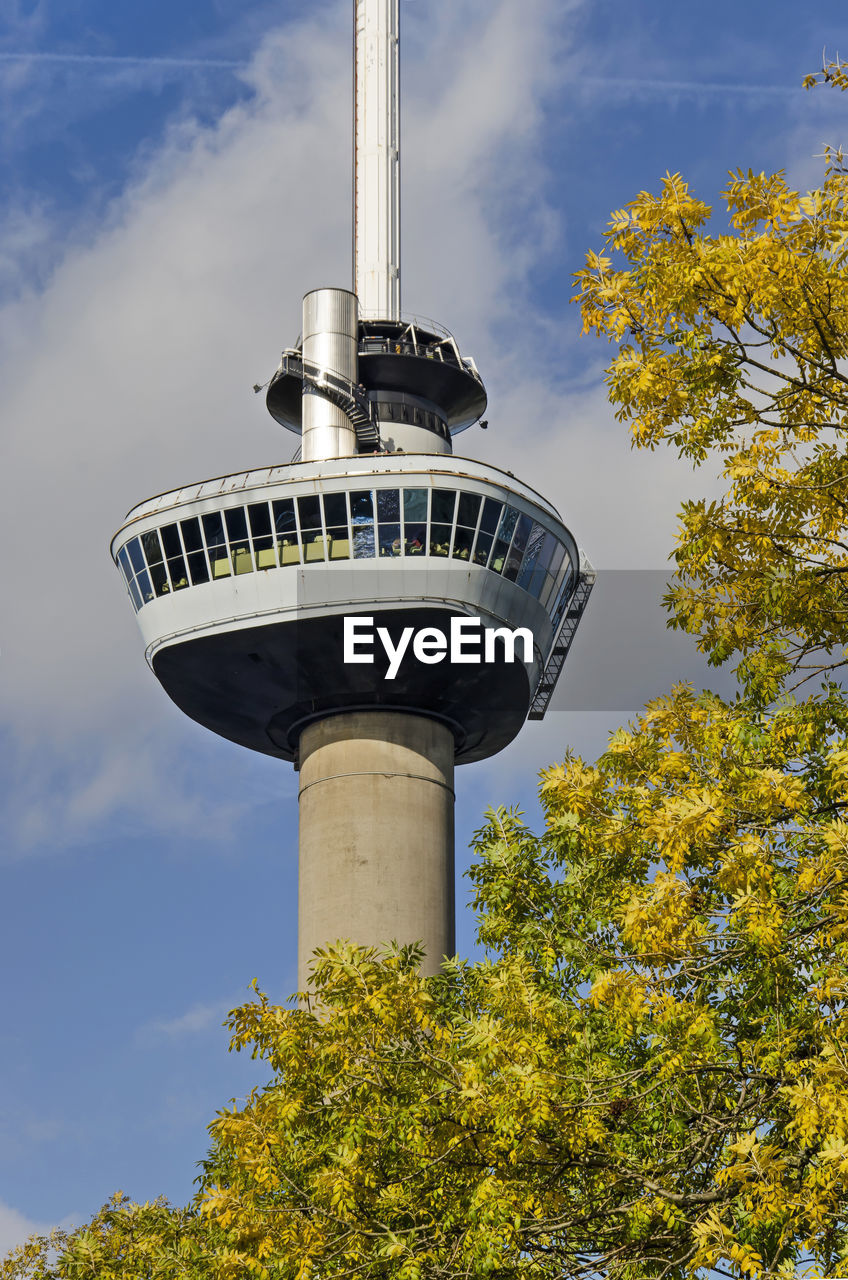 Iconic observation tower euromast rising above the trees in the park in autumn