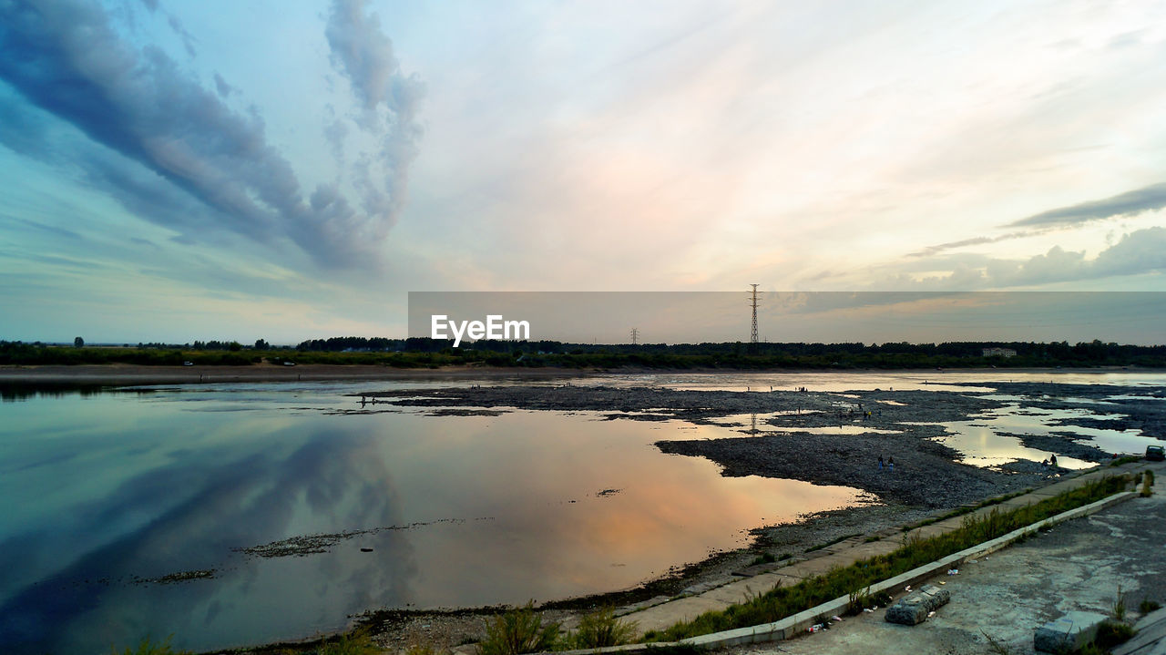 Scenic view of sea with reflection against sunset sky